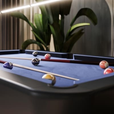 a pool table with a potted plant in the background